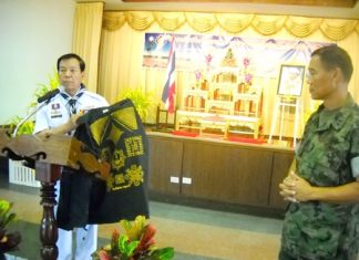 Rear Adm. Samak Noophairoj, scouts club president, presents vests covered in good luck symbols to Marine Corps Training Center commander, Vice Adm. Phongsak Phuririj.